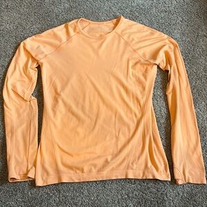 I am selling an Orange Long sleeve Shirt that is from the brand Althleta.